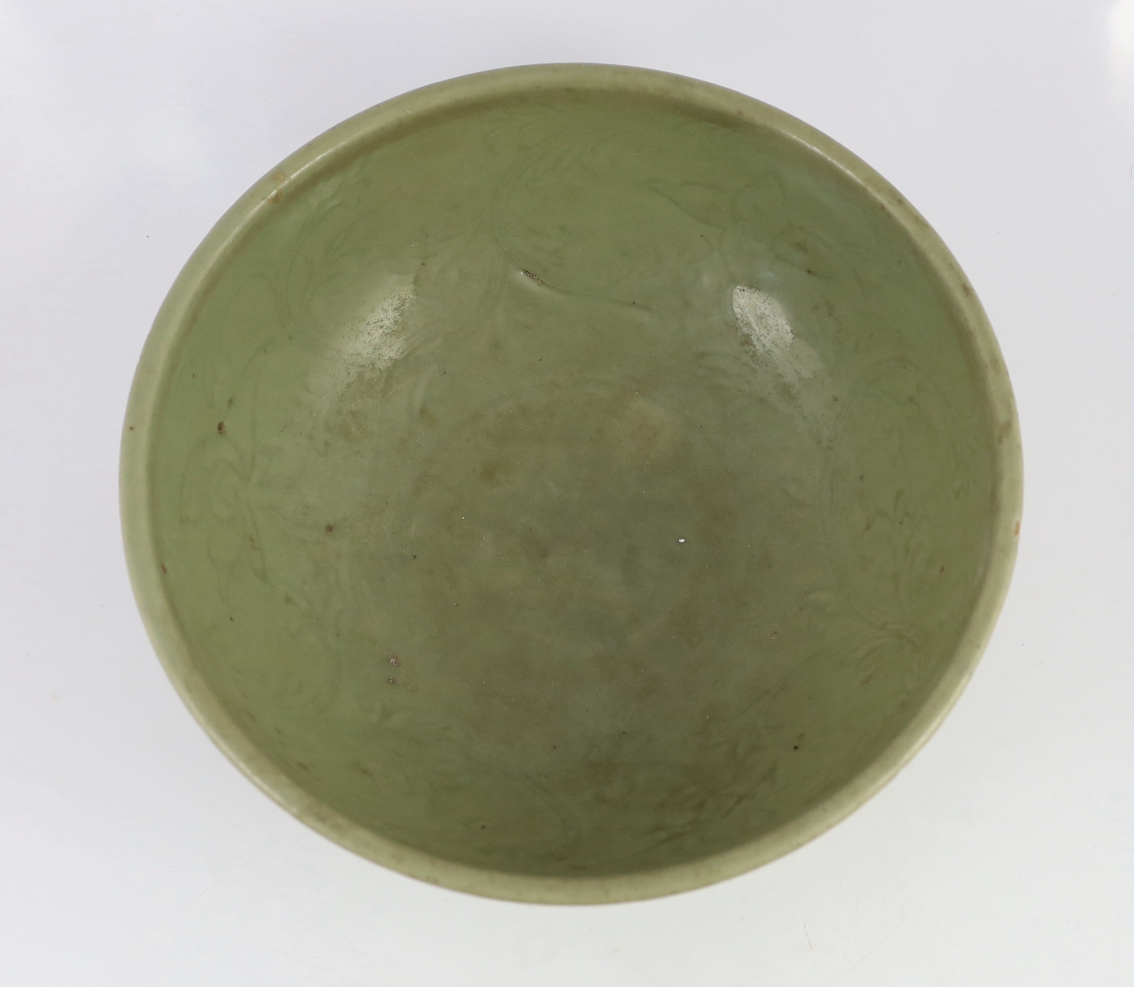 A large Chinese Ming carved Longquan celadon deep bowl, first half 15th century, scratches to glaze